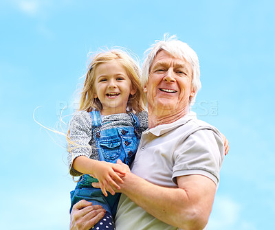 Buy stock photo Portrait of a happy grandfather holding his young granddaughter