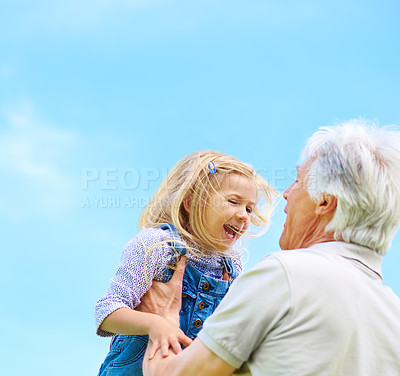 Buy stock photo Shot of a happy grandfather lifting his young granddaughter