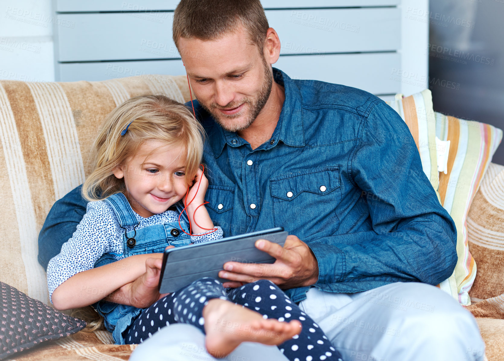 Buy stock photo Man, kid and tablet on couch for streaming, audiobook and earphones or movies on patio at house. Digital, family and dad with daughter, tech at home and video, radio and listening online on app