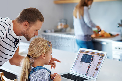 Buy stock photo Shot of a dad helping his little girl out with the laptop