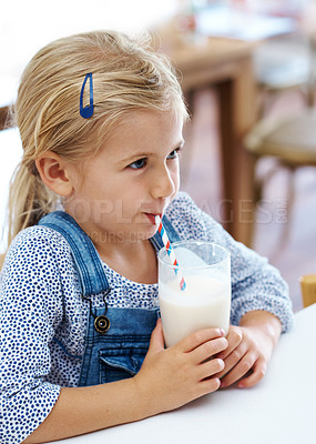 Buy stock photo Shot of a cute little girl enjoying a glass of milk