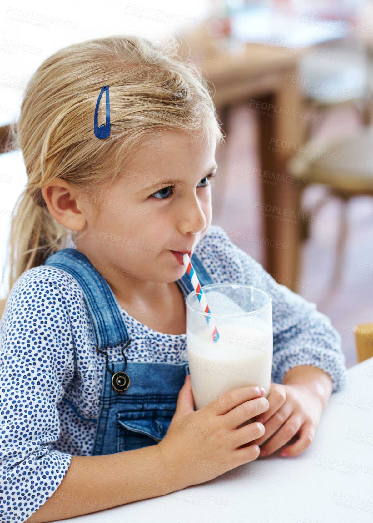 Buy stock photo Girl, child and drinking milk in home, nutrition and vitamin d liquid for growth development. Female person, kid and glass of mineral juice for calcium at kitchen table, dairy breakfast and health