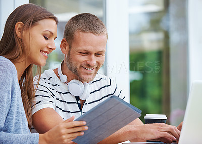 Buy stock photo Shot of a happy young couple working together outside a cafe