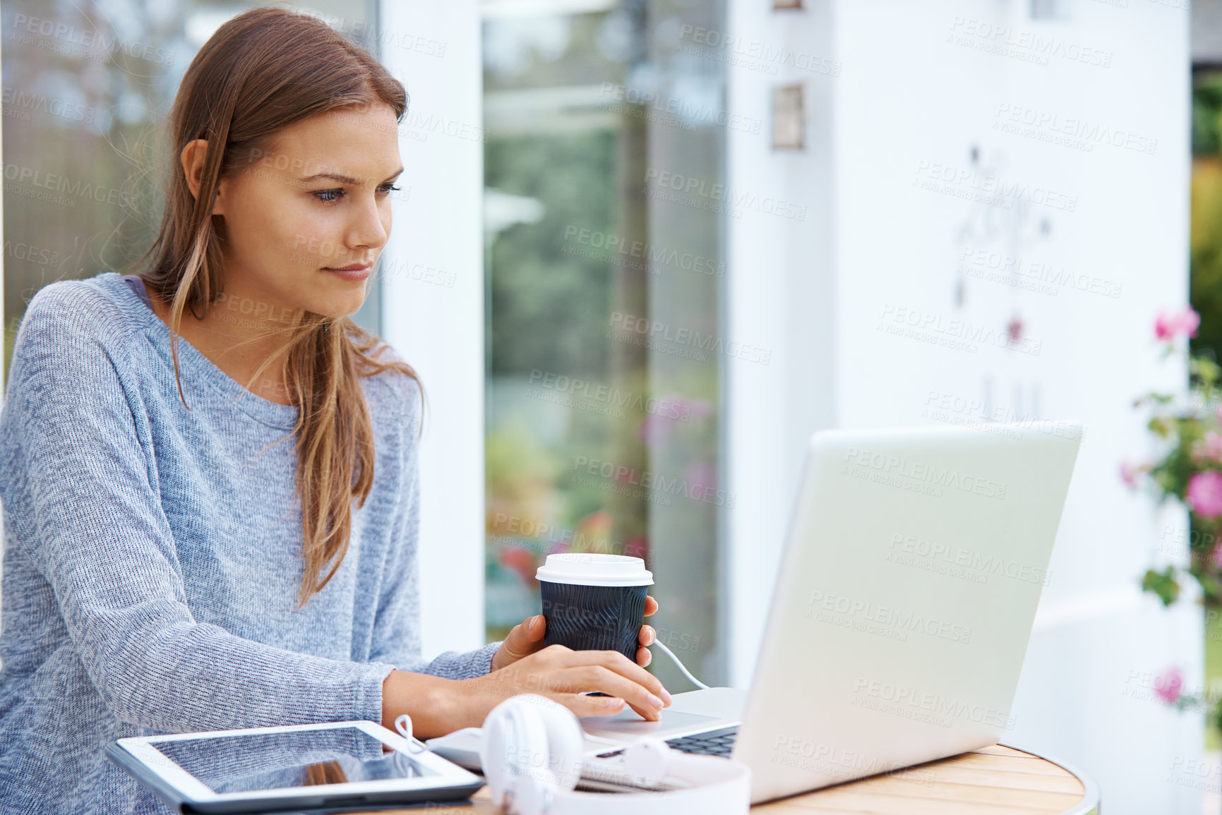 Buy stock photo Creative, woman and typing on laptop in cafe outdoor for remote work, drafting media pitch and press release. Female publicist, headphones and online for managing social accounts or planning campaign