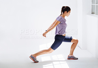 Buy stock photo Woman, fitness and stretching body with lunges for workout, exercise or training at indoor gym. Active or young female person in warm up for physical activity, performance or shape at health club