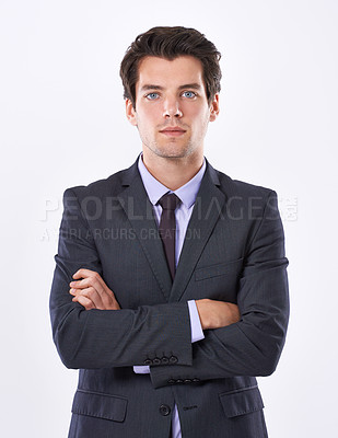 Buy stock photo Portrait of a focused businessman with an ambitious attitude standing with his arms crossed isolated against a white background. A Successful business leader looking confident while wearing a suit