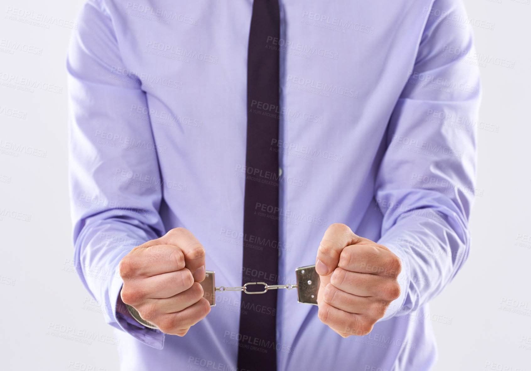 Buy stock photo Business, man and hands with cuffs in studio on white background for arrest or trapped in corporate affairs. Male person, entrepreneur and guilty as criminal for financial crime, fraud and corruption