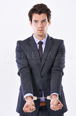 Buy stock photo Handcuffs, justice and portrait of businessman for fraud, bribery or money laundering. Law, financial crime and punishment of criminal with stealing, corruption and scam on white studio background