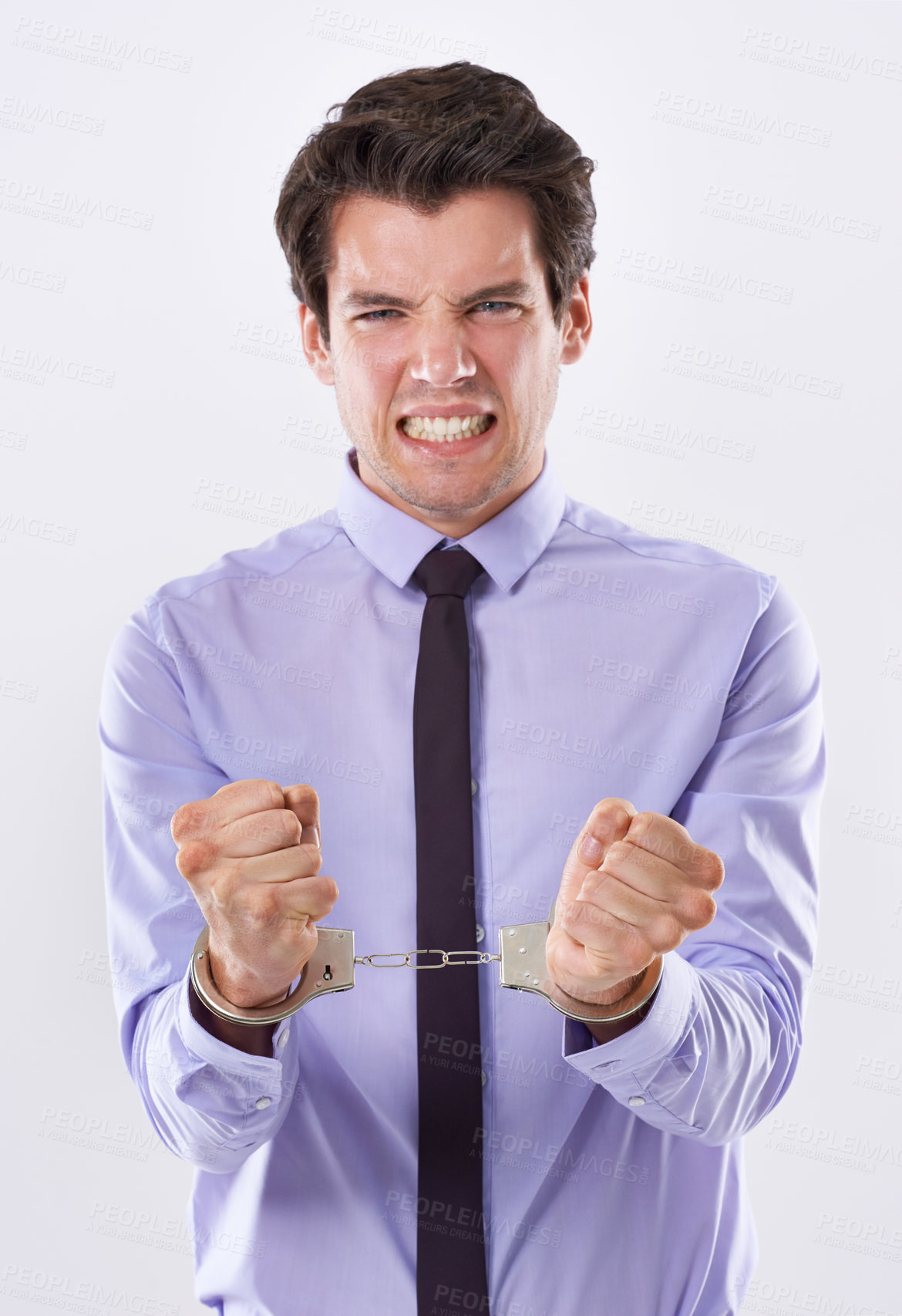 Buy stock photo Business, man and frustrated on handcuffs in studio on portrait in white background for arrest or trapped. Male person, entrepreneur and guilty as criminal on financial crime or corporate corruption