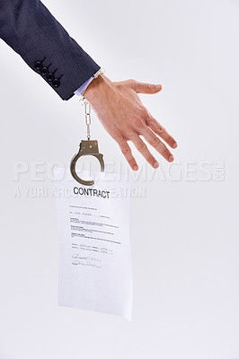 Buy stock photo Business person, contract and handcuffs with chain for job or career bound in studio on a white background. Closeup of employee with legal document or paper chained to hand for agreement or signature