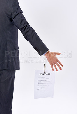 Buy stock photo Business person, contract and handcuffs with bondage for job or career in studio on a white background. Closeup of employee with legal document or paper chained to hand for agreement or signature