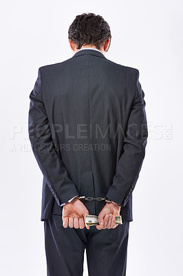 Buy stock photo Handcuffs, hands and businessman back with cash for fraud, bribery or money laundering. Law, financial crime and punishment of criminal with stealing, corruption and scam on white studio background