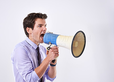 Buy stock photo Business man, shout and megaphone by ear in studio for communication, announcement and breaking news. Employee, noise and loudspeaker on white background for broadcast, warning and corporate protest