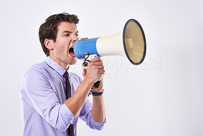 Buy stock photo Businessman, upset and megaphone in studio for communication, announcement and breaking news. Employee, angry and loudspeaker on white background for broadcast, noise and corporate propaganda protest