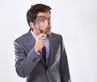 Buy stock photo Portrait, eye and businessman with magnifying glass, investigation and audit at company on white studio background. Face, male employee and PI with compliance and fair trade evidence or information