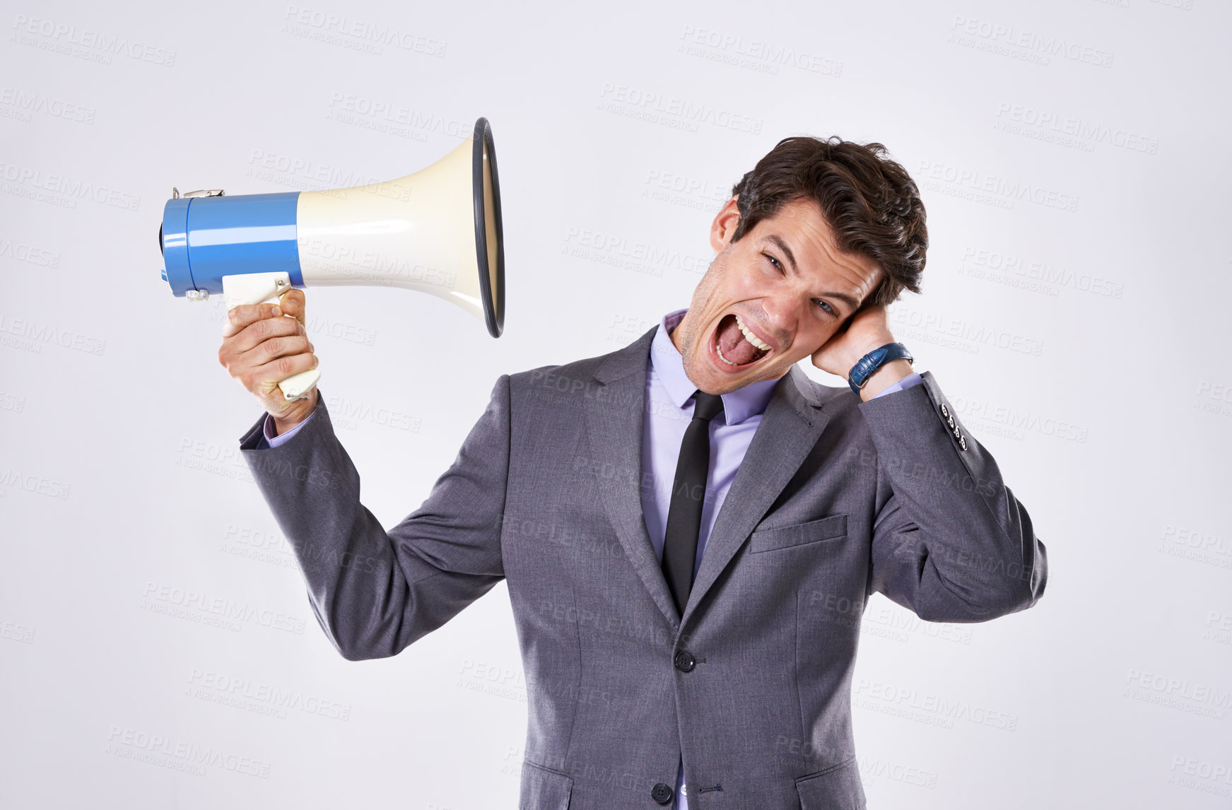 Buy stock photo Business man, loud and megaphone in studio by ear for communication, announcement and breaking news. Employee, noise and opinion on white background for broadcast, voice and corporate propaganda