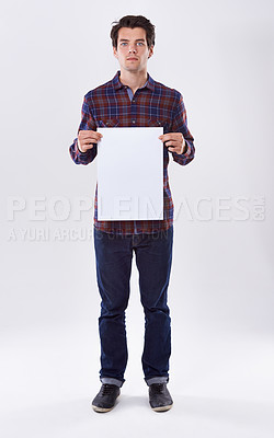 Buy stock photo Man, portrait and blank poster in studio, paper announcement and information on white background. Male person, empty placard and commercial board for news, mockup space and offer promotion display