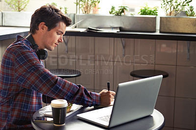 Buy stock photo Cropped shot of a young man working in a cafe during lunch 