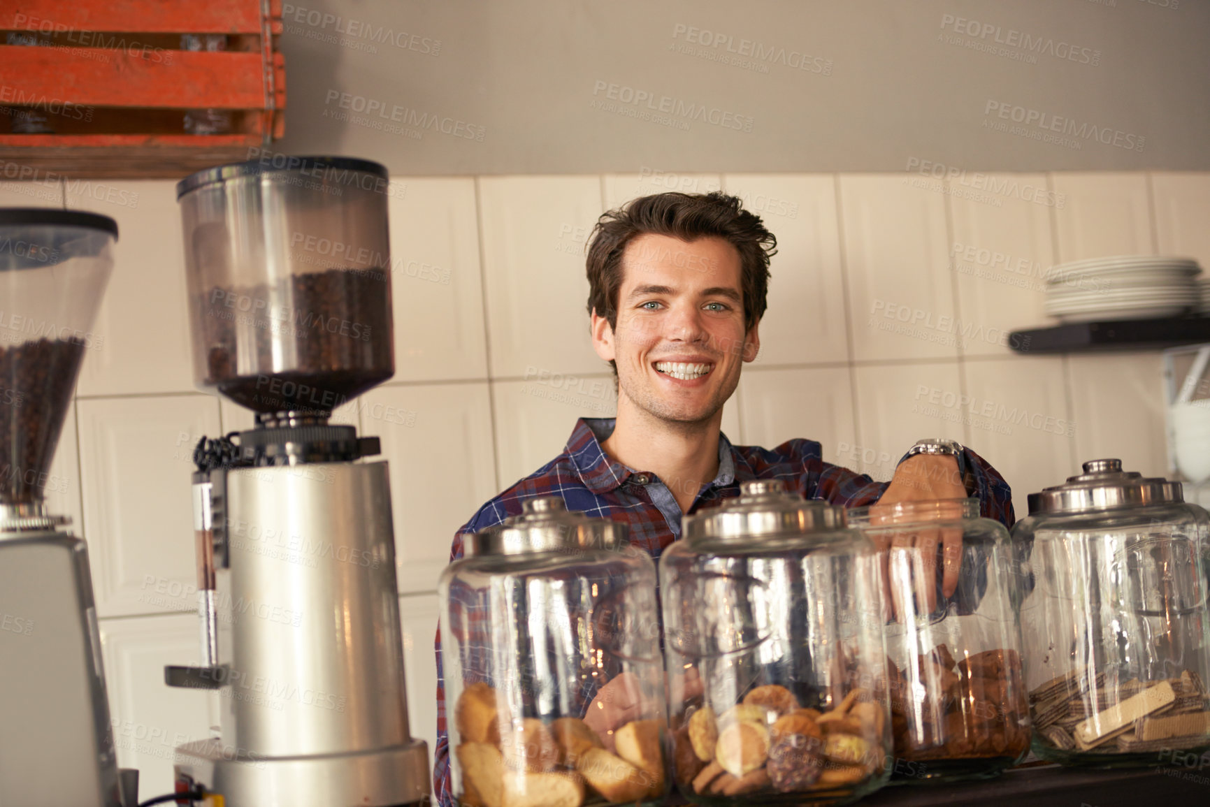 Buy stock photo Portrait, happy and barista in cafe with cookies, order or snacks in service industry. Smile, man waiter or biscuits on counter for sale, customer care or complimentary with coffee in bakery in Spain