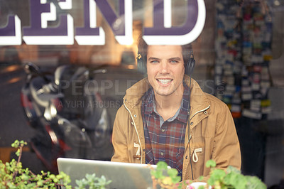 Buy stock photo Man, portrait and laptop with headphones in coffee shop for remote work, music or smile in morning. Person, journalist or writer with computer, happy or online streaming by window for article in cafe