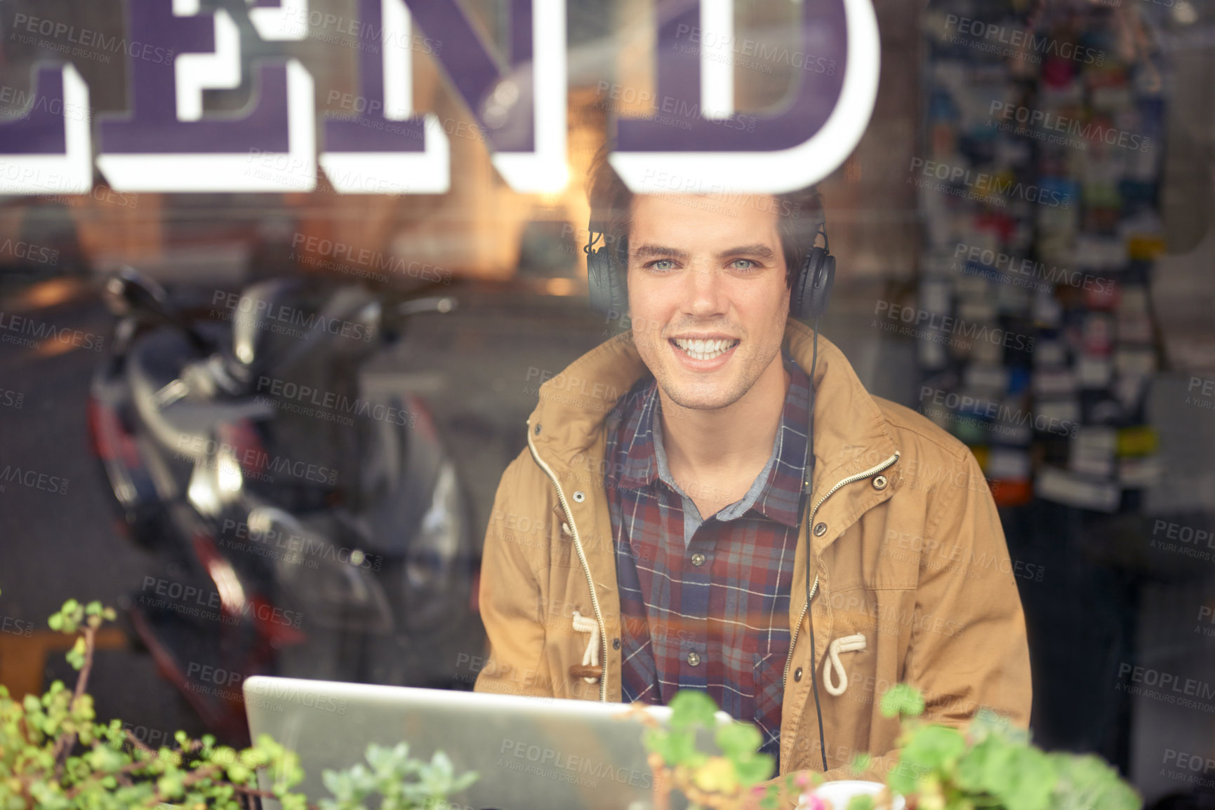 Buy stock photo Man, portrait and laptop with headphones in coffee shop for remote work, music or smile in morning. Person, journalist or writer with computer, happy or online streaming by window for article in cafe