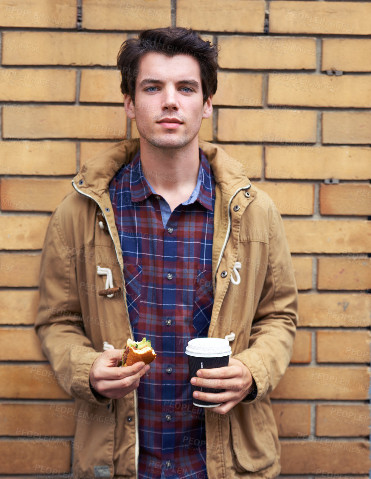 Buy stock photo Portrait, man and outdoor with takeaway coffee on wall for breakfast, food or morning as web designer. Male person, break and lunch for nutrition, wellness or meal at company or digital agency in USA