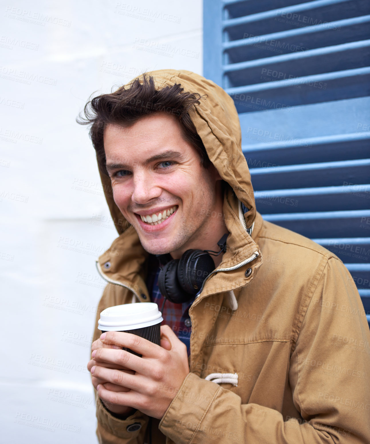 Buy stock photo Man, portrait and coffee outdoor for travel, relax and break with headphones, hoodie or takeaway cup. Male person, happy and latte by sidewalk for winter, tourism or warm beverage or drink in morning