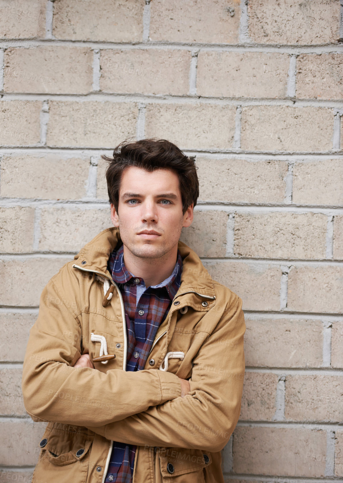 Buy stock photo Man, confident and portrait at brick wall with fashion, attitude or relax on sidewalk. Student, arms crossed and winter streetwear in city with serious, style or edgy in urban New York on commute