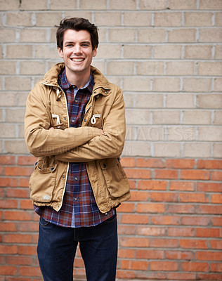 Buy stock photo Happy, man and arms crossed for fashion on brick wall with style, clothes and outfit as web designer In New York. Male person, employee and outdoor with smile, confidence and pride for career growth