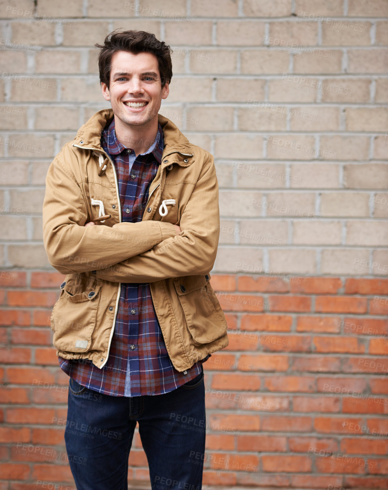 Buy stock photo Happy, man and arms crossed for fashion on brick wall with style, clothes and outfit as web designer In New York. Male person, employee and outdoor with smile, confidence and pride for career growth