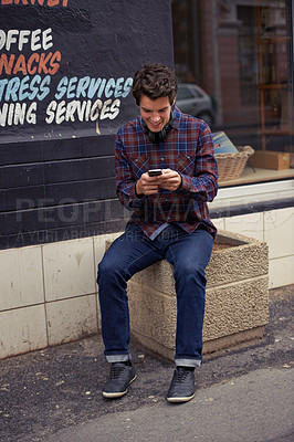 Buy stock photo Man, reading and texting in city with phone, chat and happy for notification with mobile app for connection. Person, smartphone and click with contact, smile and scroll with social media in street