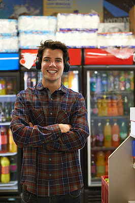 Buy stock photo Headphones, portrait and confident happy man in store for music or grocery shopping. Face, audio and person with arms crossed for streaming hip hop sound, audiobook and listen to radio in supermarket