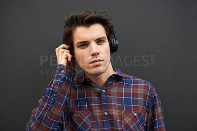 Buy stock photo Headphones, portrait and man listening to music, podcast and radio isolated on black studio background. Audio, face and person streaming service for jazz sound, audiobook and media with technology