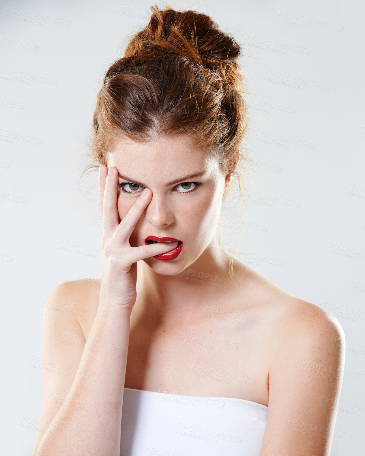 Buy stock photo Woman, edgy and bite finger in portrait with makeup, cosmetics and mysterious in studio. Person, beauty and gesture on white background for aesthetic, confidence and hand on face with red lipstick