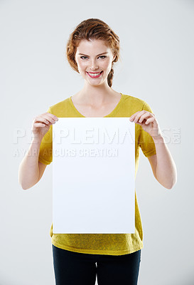 Buy stock photo Studio, woman and portrait with poster mockup for advertising, marketing and announcement for product placement. Cheerful, sales person and blank billboard by white background, promotion and branding