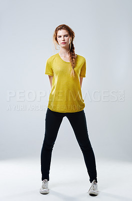 Buy stock photo Serious, woman and portrait for fashion in studio with tshirt, trendy outfit and natural beauty of cosmetic glow. Girl, stretching and casual clothes for style, makeup and pride on white background