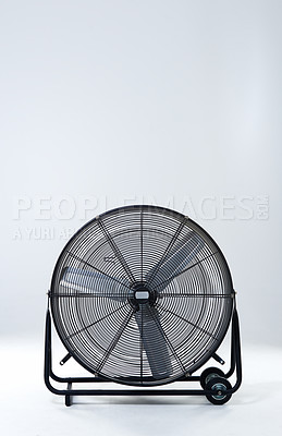 Buy stock photo Large, metallic fan and electric appliance with blades, steel and industry on gray studio background. Empty, breeze and air conditioning with mockup space, promotion for product and stationary