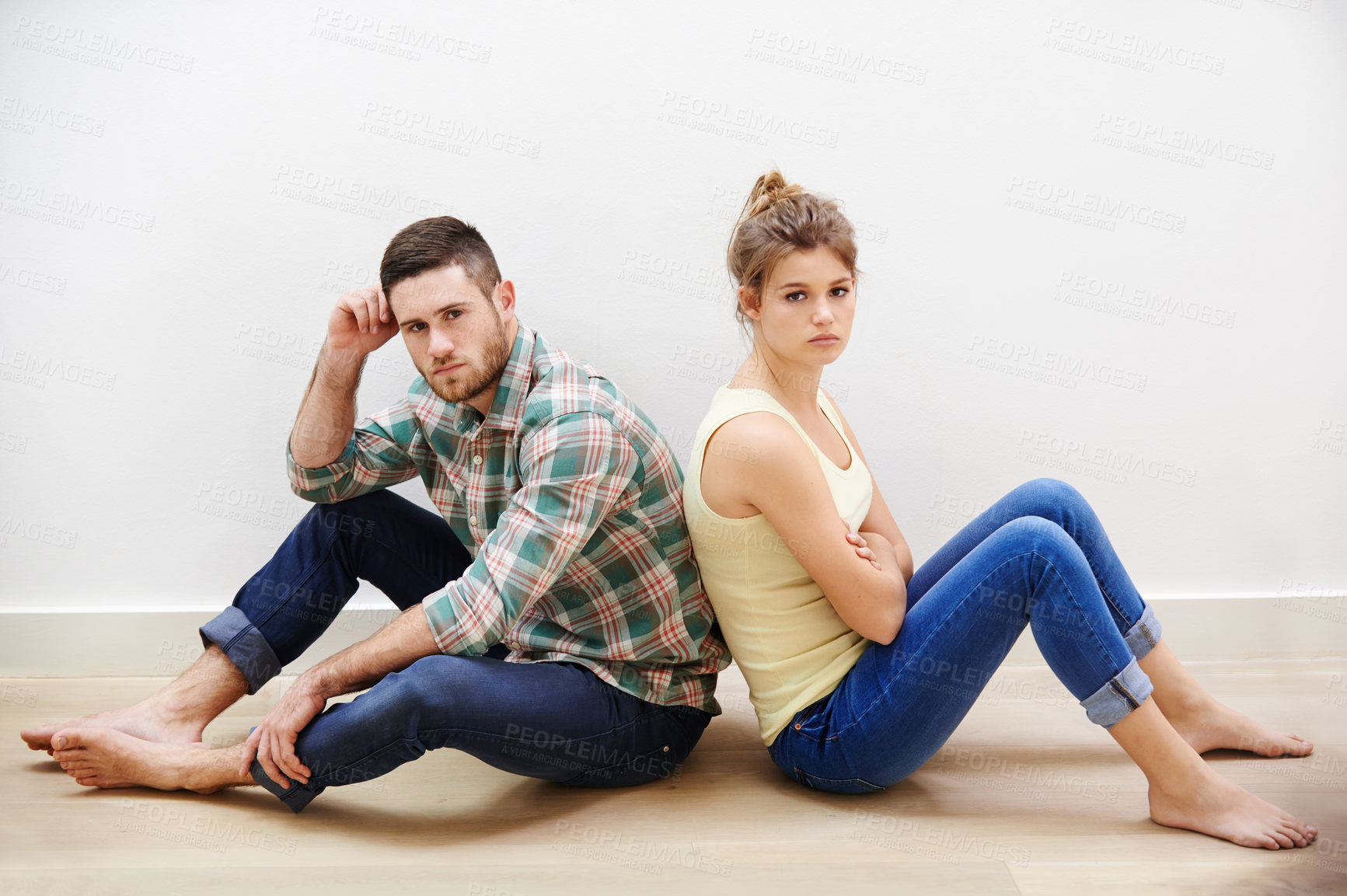 Buy stock photo Couple, sad and conflict in home for portrait, fighting and toxic relationship with anxiety. Man overthinking, sad woman and sitting on floor with depression, frustrated and argue in living room