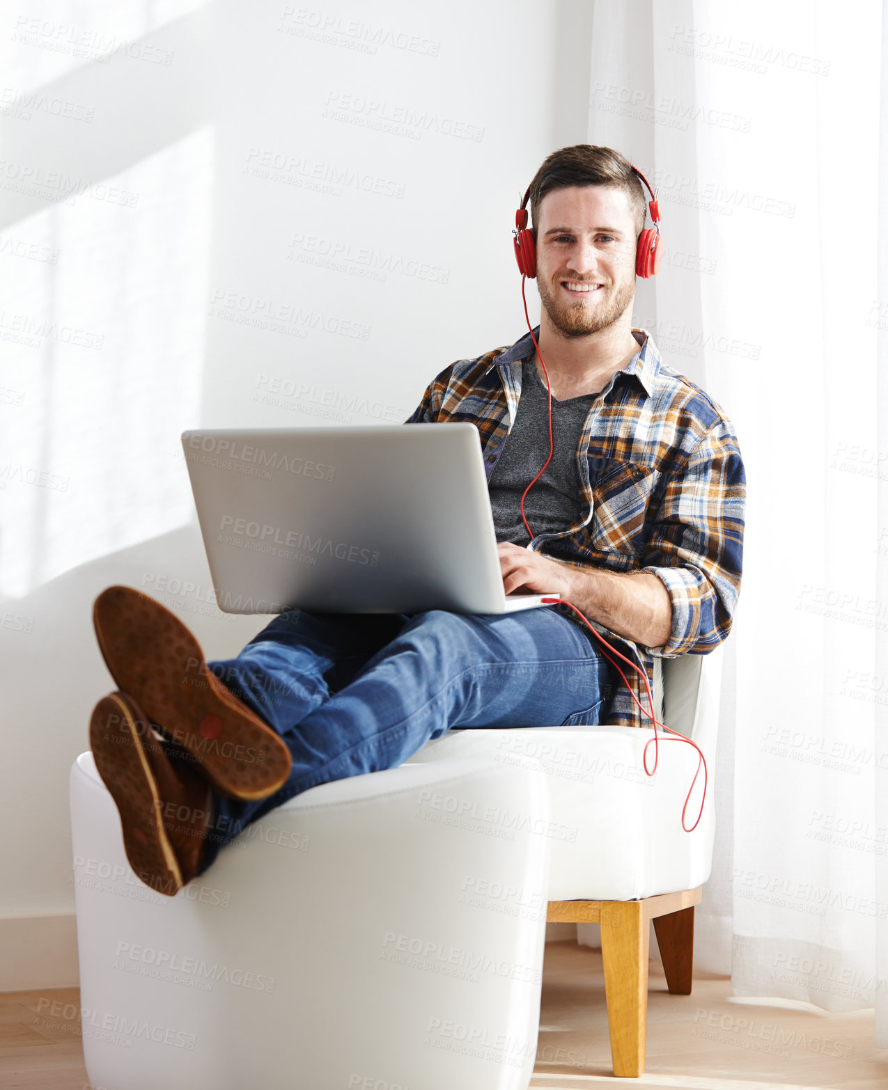 Buy stock photo Man, home and smile on laptop with headphones for editing videos as videographer with remote work. Male person, employee and happy on portrait as freelancer for audio, music and streaming service