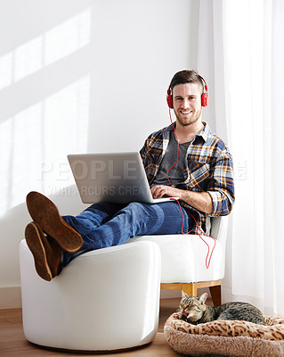 Buy stock photo Man, house and cat on laptop with headphones for editing videos as videographer with remote work. Male person, pet and happy or smile on portrait as freelancer for audio, music and streaming service