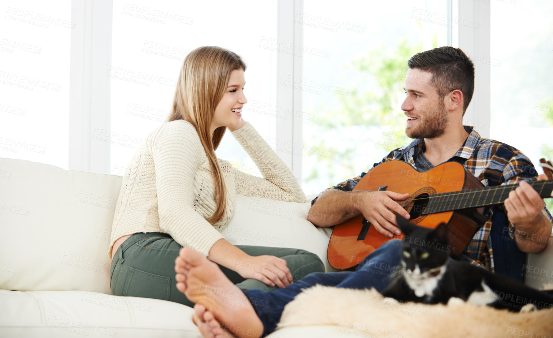 Buy stock photo Couple, guitar and relax in house on sofa for conversation, bonding and love together with romance. Man, woman and music on apartment couch for talking, relationship and chill on weekend with singing