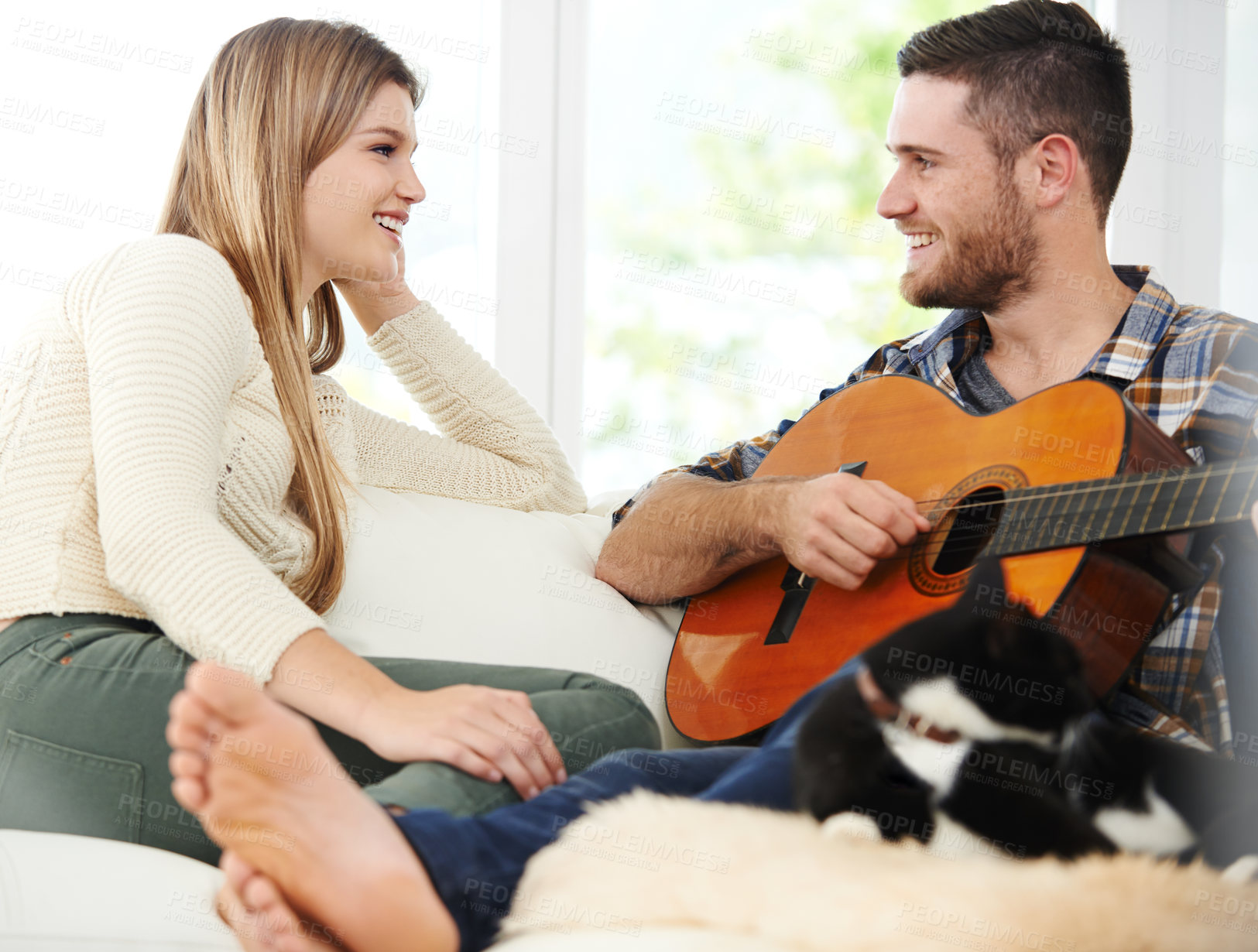 Buy stock photo Couple, happy and guitar in house on sofa for bonding, singing and love together with romance. Man, woman and connection on apartment couch for talking, relationship and chill on weekend with smile