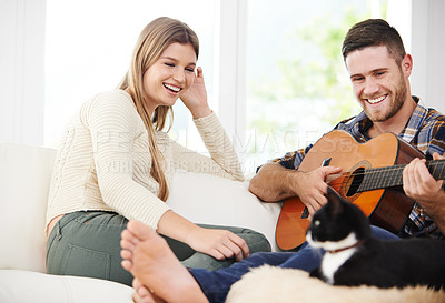 Buy stock photo Woman, man and playing guitar for bonding, together and relationship with love or support in home. Happy couple, instrument and music for fun, relax and comfort in lounge for session, peace or memory