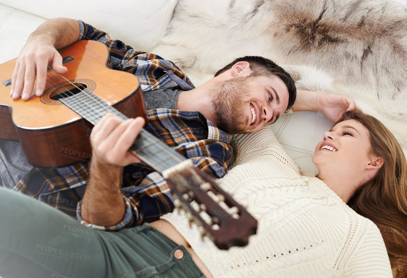 Buy stock photo Happy couple, care and playing guitar for fun, together and relationship with love or support in home.  Woman, man and music instrument for bonding, relax and joy in lounge for song, peace and memory