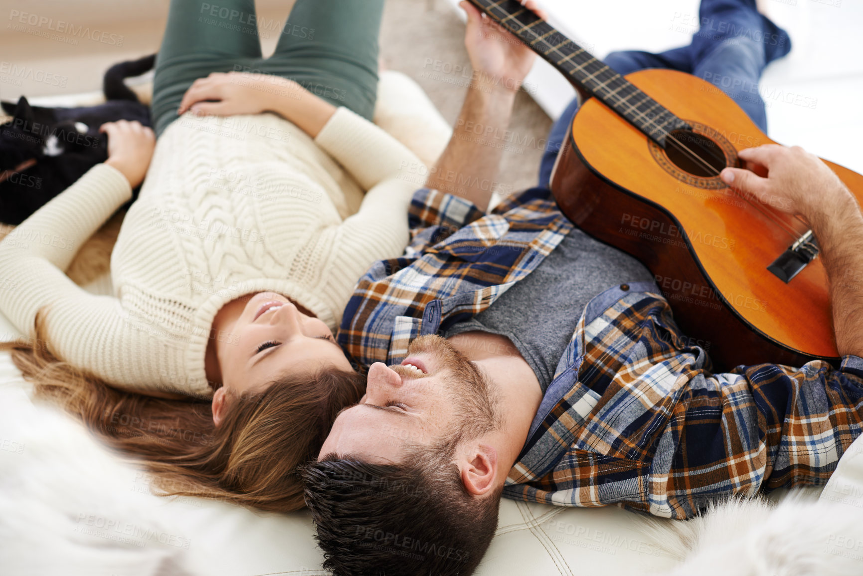 Buy stock photo Happy couple, floor and playing guitar for bonding together in relationship with love or support in home. Woman, man and music instrument for fun, relax and joy in lounge for song, peace and memory