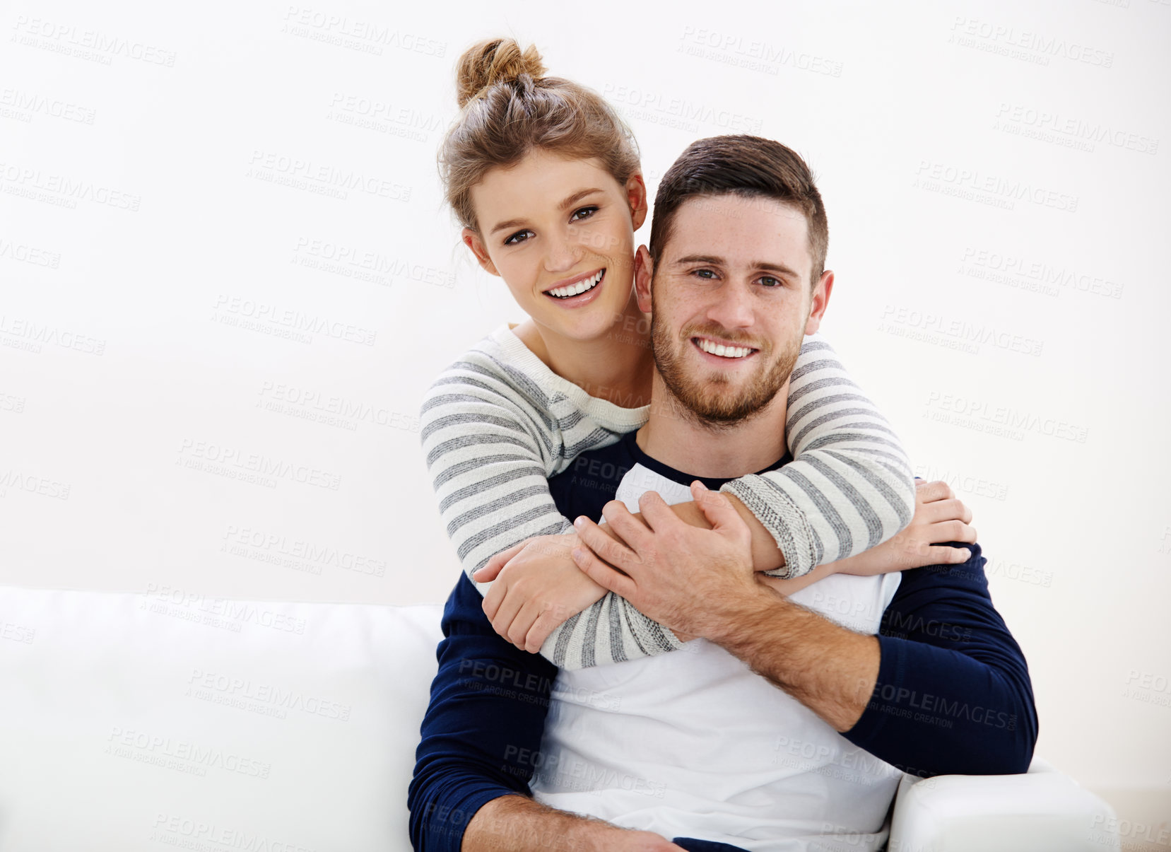 Buy stock photo Portrait, hug and happy couple in home with love, care and bonding together on sofa. Face, man and woman piggyback in living room for connection, healthy relationship and  support partner in marriage