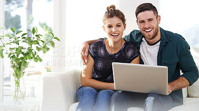 Buy stock photo Portrait of a happy young couple using a laptop while relaxing at home together