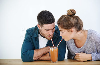 Buy stock photo Love, milkshake and cafe with couple on date for romance, bonding and happiness. Smoothie, coffee shop and care with man and woman sharing drink at restaurant for summer, break and relationship
