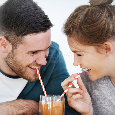 Buy stock photo Love, milkshake and smile with couple on date for romance, bonding and happiness. Smoothie, coffee shop and care with man and woman sharing drink at restaurant for summer, break and relationship