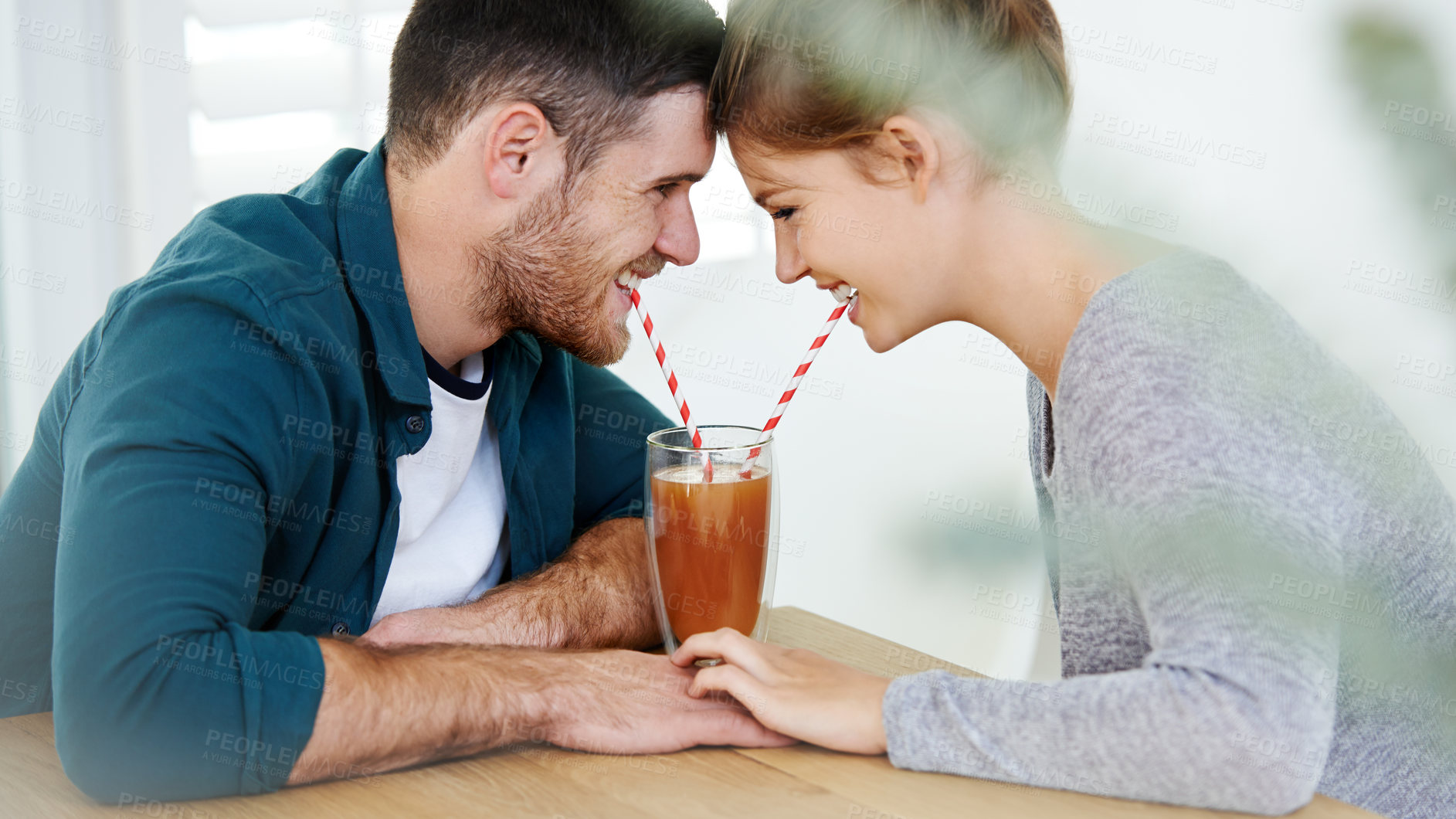 Buy stock photo Love, milkshake and holding hands with couple on date for romance, bonding and cafe. Smoothie, coffee shop and care with man and woman sharing drink at restaurant for summer, break and relationship